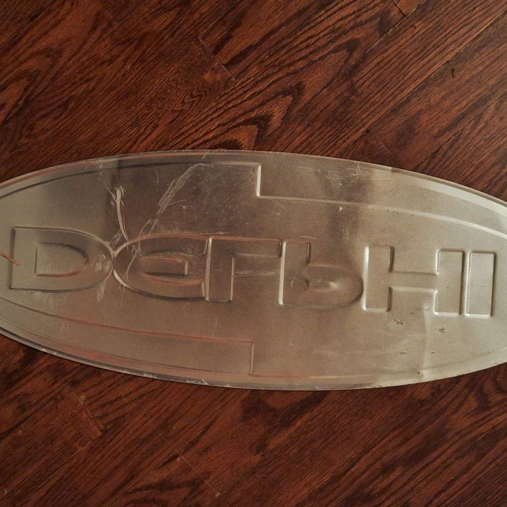 Delphi metal sign still has original plastic on front